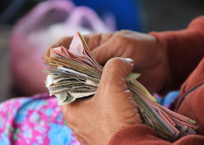 Hands counting currency notes
